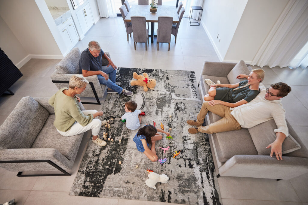 Light tile flooring and natural area rug in a bright Dothan AL living room designed to feel cooler