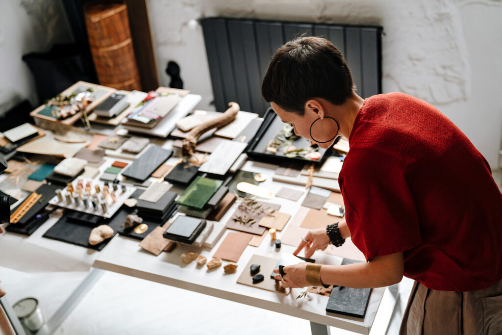 Interior designer selecting tile and stone samples from a material palette