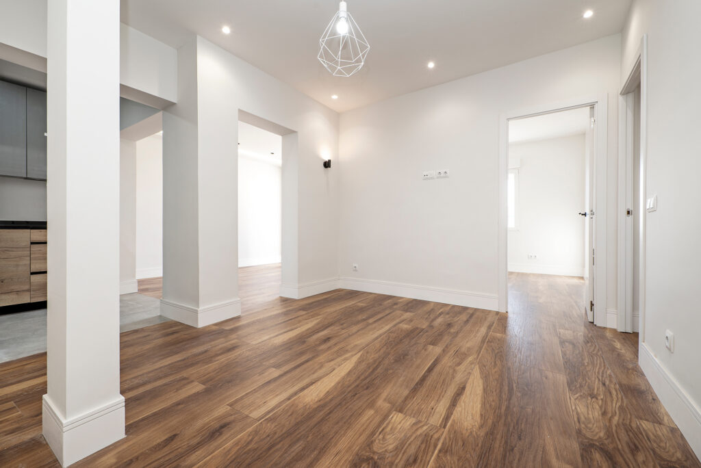 Wide plank hardwood flooring with natural grain in an open concept kitchen and living space